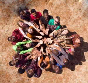 Diverse group of people putting hands together in circle